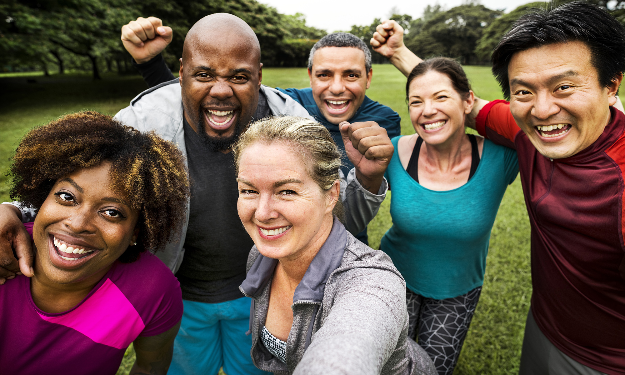 Group of cheerful diverse friends in the park